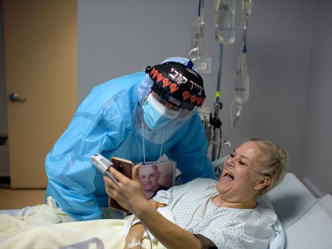 A Covid patient FaceTimes her family alongside her doctor in a Houston hospital. Texas has also seen cases surge. Picture: AFP