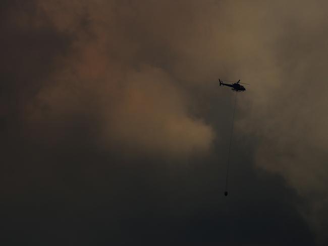 A helicopter picks up water near the bushfire at Lachlan. Picture: LUKE BOWDEN