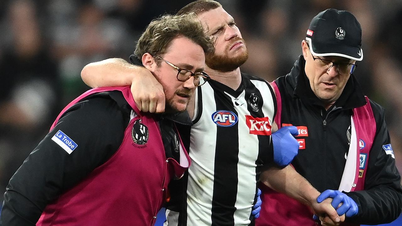 Taylor Adams is helped from the ground by trainers on Saturday.