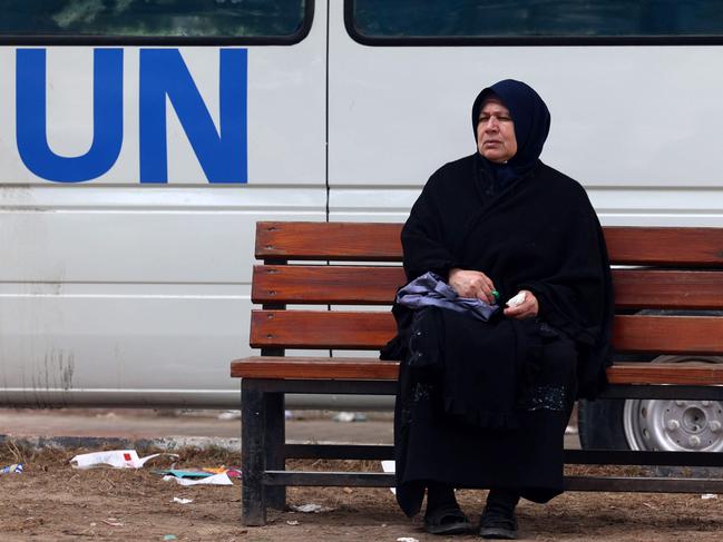 A displaced Palestinian woman sits on a bench as she waits outside a clinic of the United Nations Relief and Works Agency for Palestine Refugees (UNRWA) in Rafah. Picture: AFP