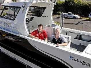 Sailfish Marine factory manager Craig Soward (left) and sales manager Ian Drew prepare the $140,000 2400 Gamefisher for the trip to the Sanctuary Cove International Boat Show that starts tomorrow. . Picture: jay cronan