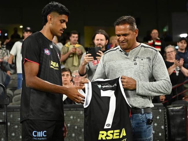 Nasiah Wanganeen-Milera of the Saints is presented with his jumper from Nicky Winmar during the round one AFL match between the Saints and the Magpies at Marvel Stadium. Picture: Quinn Rooney/Getty Images.