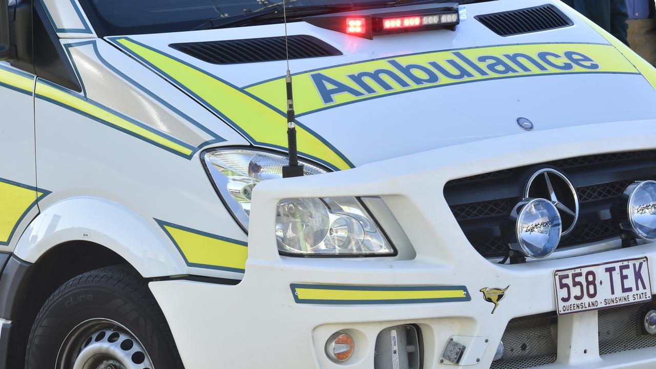 Emergency crews treating motorbike rider after forest crash