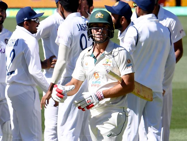 Australia's batsman Joe Burns (C) walks back to the pavilion as Indian players celebrate his dismissal on day two of the first cricket Test match between Australia and India in Adelaide on December 18, 2020. (Photo by William WEST / AFP) / --IMAGE RESTRICTED TO EDITORIAL USE - STRICTLY NO COMMERCIAL USE--