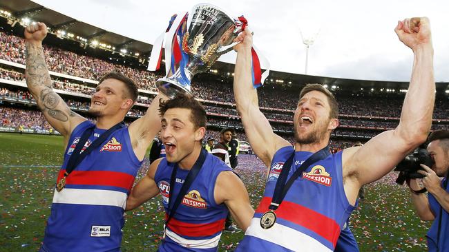 Clay Smith, Luke Dahlhaus and Matthew Boyd celebrate the 2016 premiership. Picture: David Caird