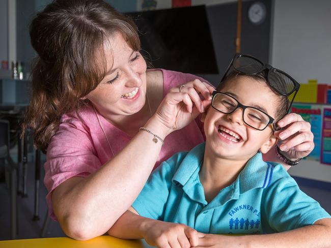 Melbourne University optometry students are visiting the most disadvantaged schools in Melbourne to give children free eye tests and then free glasses for those who needed them. Erica Barclay( final year doctor of optometry student) with grade 1 Fawkner Primary School student, Adam,6. Picture: Sarah Matray