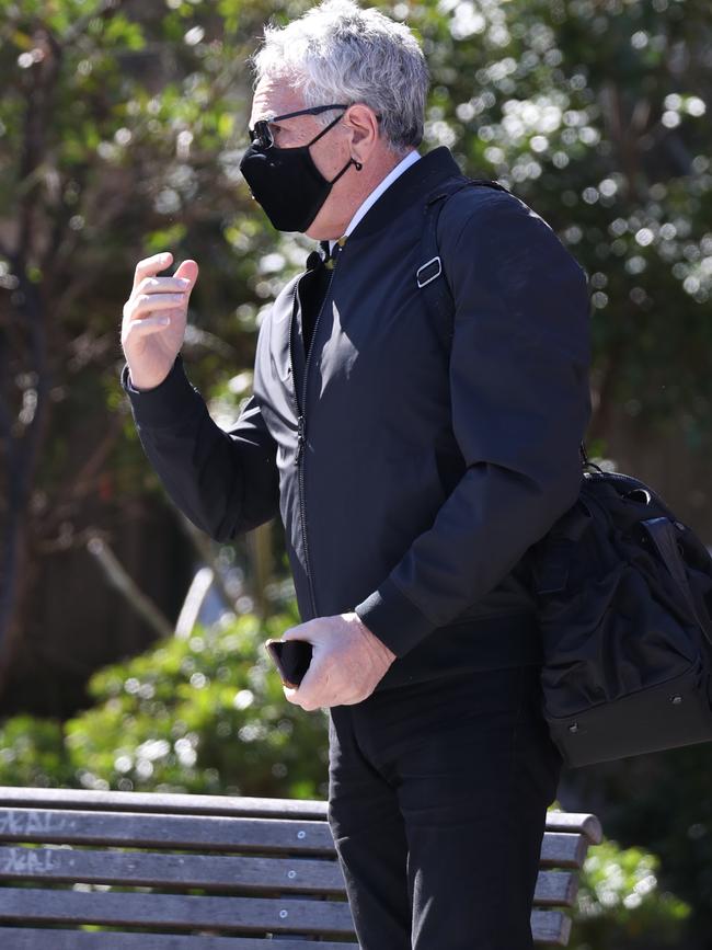 Michael Podgoetsky put on a mask after being challenged by The Daily Telegraph. Picture: John Grainger