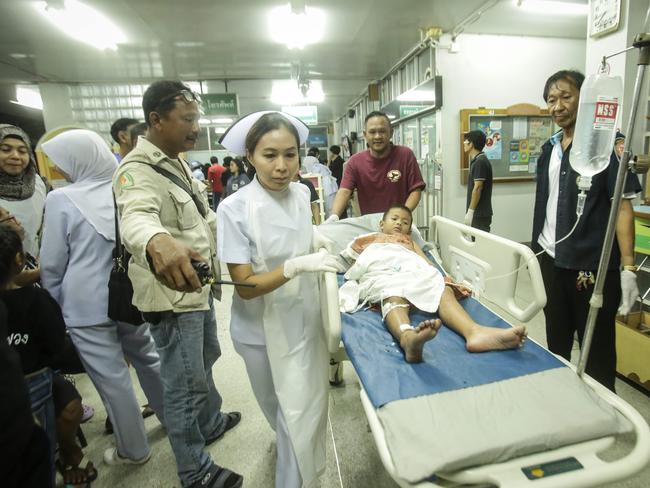 An injured child is brought through a hospital after a bombing in the southern Thai province of Pattani. Picture: AFP/Tuwaedaniya Meringing