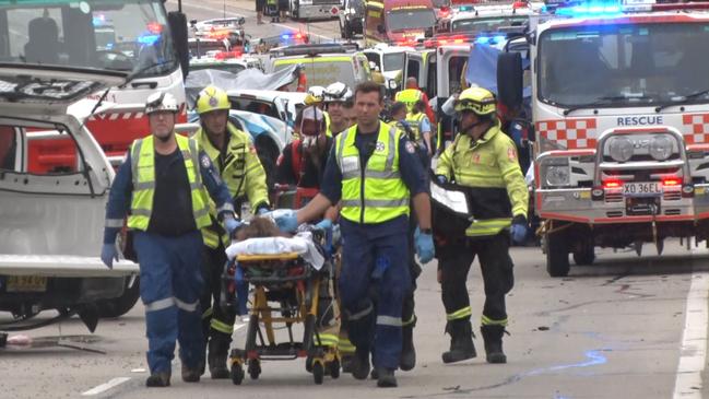 Paramedics accompany a patient from the scene for further medical help. Picture: TNV