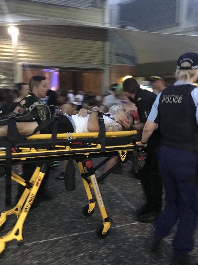 A man is taken away on a stretcher at Homebush.