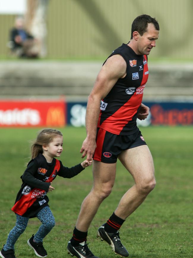 Jason Porplyzia, with his daughter Rori, has left the game a winner. Picture: Mike Burton/AAP