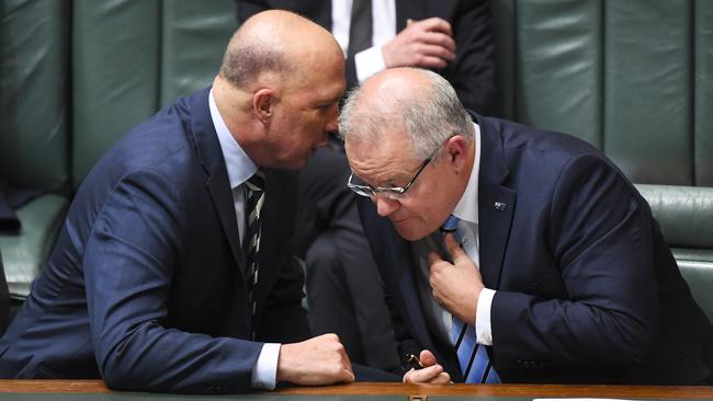 Prime Minister Scott Morrison (right) speaks to Home Affairs Minister Peter Dutton during House of Representatives Question Time.