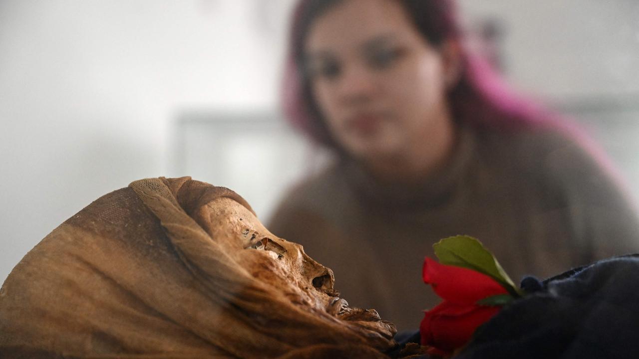 Daniela Betancourt, researcher at the National University of Colombia, observes a mummy in the Jose Arquimedes Castro mausoleum museum. Picture: Raul Arboleda / AFP