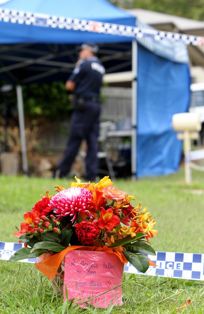 Local residents lay flowers at the scene at Upper Coomera on the Gold Coast. Picture: Mike Batterham