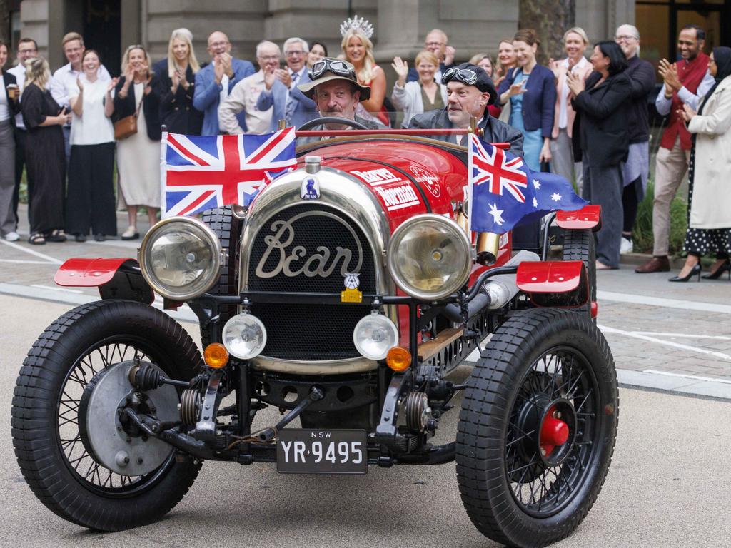 Re-enacting the journey from London to Melbourne originally undertaken in 1927 by Australian adventurer Francis Birtles, Daily Telegraph cartoonist Warren Brown and editor-at-large Matthew Benns are waved off outside Australia House, London. Picture: Jamie Lorriman