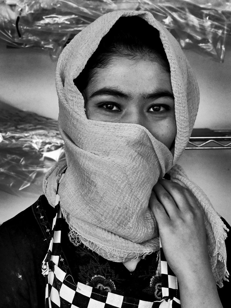 FACES OF LOCKDOWN: Parwana Parwana, 20, of Guildford, at the New Sydney Bakery in Fairfield, where she works. Photo: Jeremy Piper