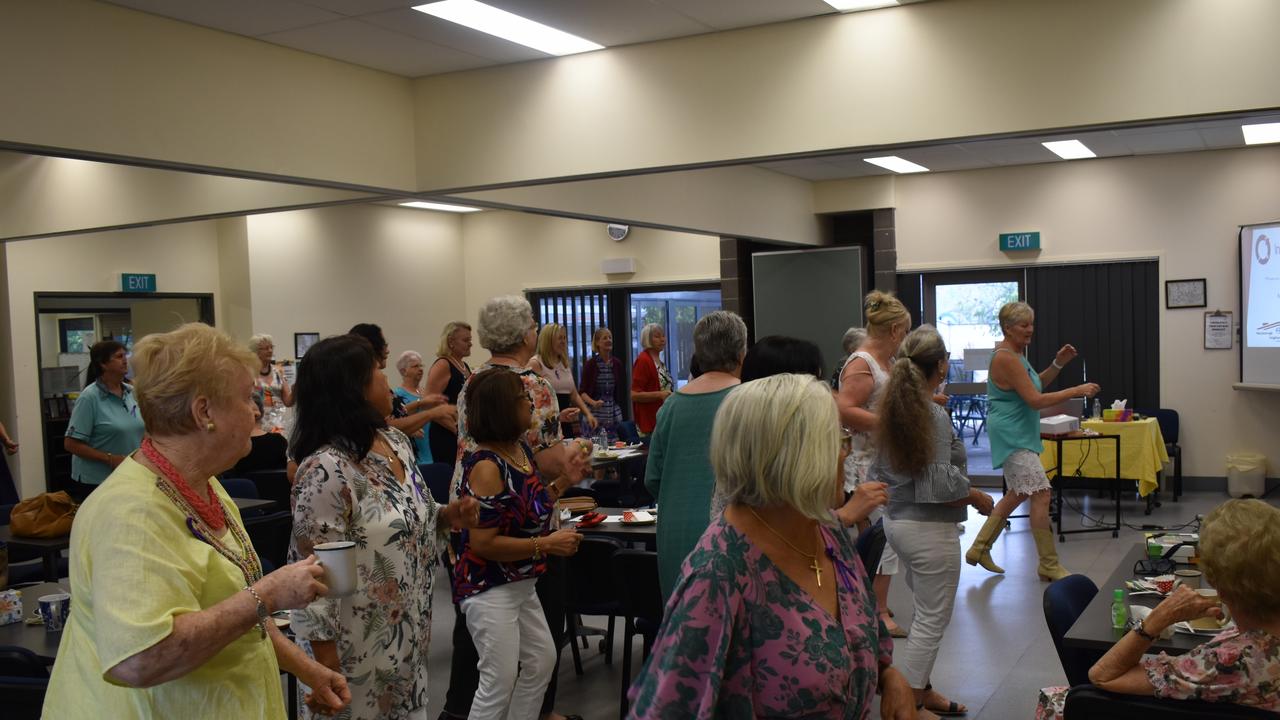 (L) People attending the International Women's Day morning tea at the Maryborough Neighbourhood Centre dance to celebrate International Women's Day.