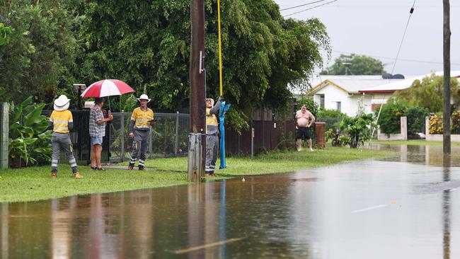 Ergon Energy workers look to restore power to Campbell Street in Gordonvale after heavy rain caused flooding to the area. Picture: Brendan Radke