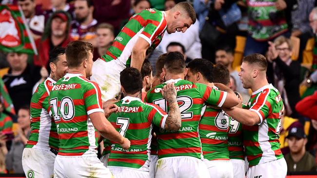 Damien Cook is congratulated by Rabbitohs teammates after scoring a try against the Broncos. Picture: Getty Images