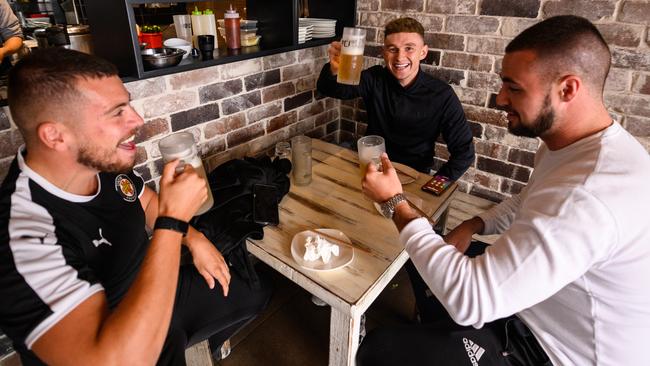 A group of men drinking beer at 'Soy Restaurant' in Bondi Beach. Picture: AAP Image/James Gourley