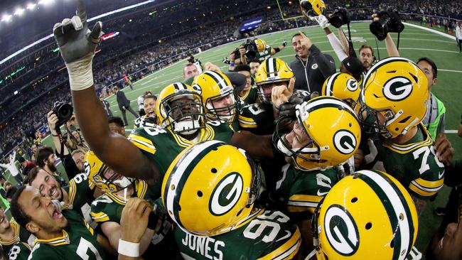 Green Bay Packers celebrate after Mason Crosby #2 of the Green Bay Packers kicked a last-second field goal to defeat the Dallas Cowboys.