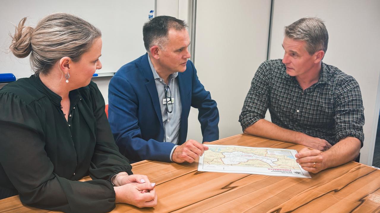 Woolworths' Nicole Sucic and Metro managing director Justin Nolan with Parramatta MP Andrew Charlton, discussing the closure of the store at Pendle Hill.