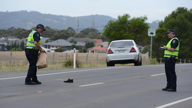 Police examine a shoe on the road at the scene of the fatal accident on Black Rd, O'Halloran Hill. Picture: Brenton Edwards/AAP