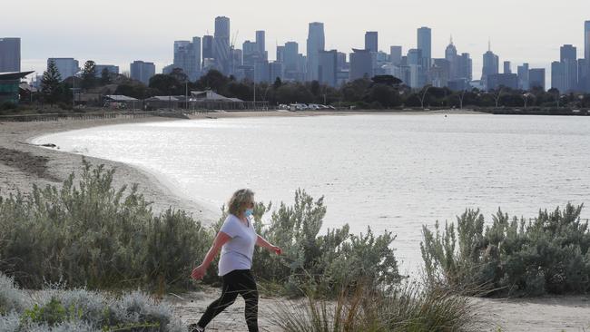 A woman gets her daily exercise near Port Melbourne beach on Monday. Picture: David Crosling