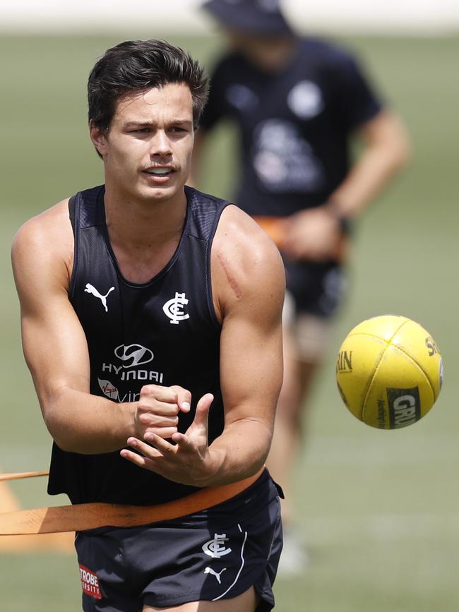 Jack Silvagni handballs during a training session.