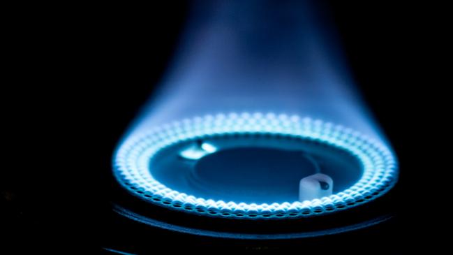 Blue flames from gas stove burner. Closeup shot of blue flames from a kitchen gas range