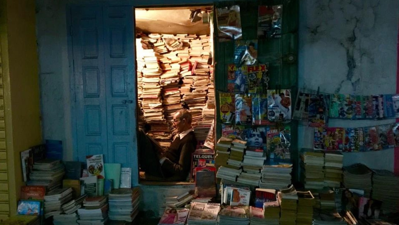 A street librarian in France Credit: TRAVELMOMENTCAPTURES