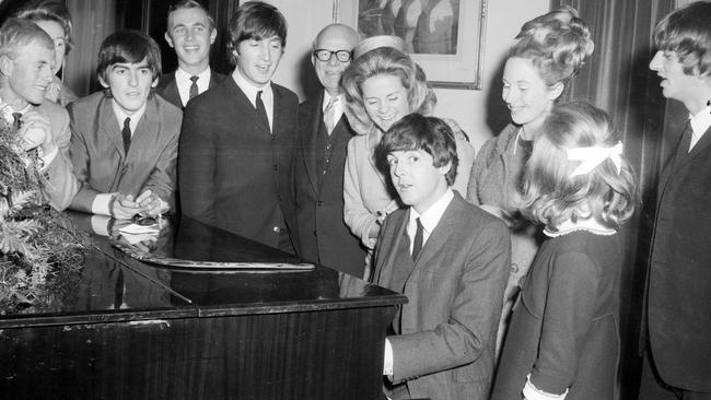 Paul McCartney playing the piano during The Beatles visit at the Melbourne Town Hall during a State Reception. Picture: HWT