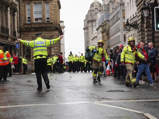Police and emergency personnel deal with the incident on Water Street. Picture: Owen Humphreys/PA via AP