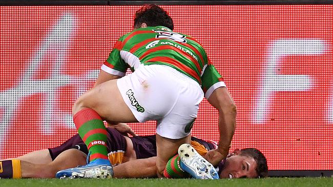 James Roberts leans over Corey Oates after the incident. Picture: Dan Peled