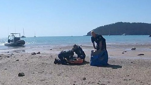 Rescuers work to save a 12-year-old girl after yesterday’s shark attack near Cid Harbour. Picture: RACQ