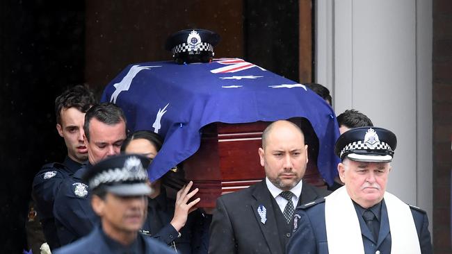 Fellow officers carry Constable Glen Humphris’s casket to the hearse on Friday. Picture: Quinn Rooney/Getty Images