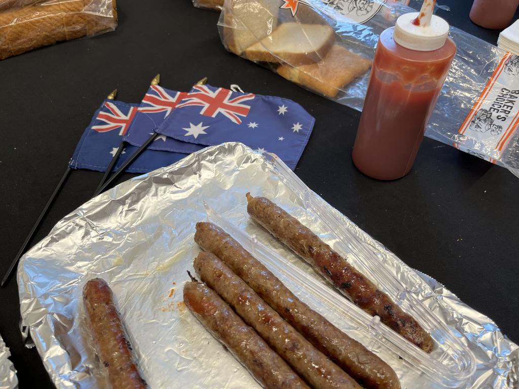 Sausage sizzle in the Australian consulate. Not a hot dog bun in site. Picture: Benedict Brook