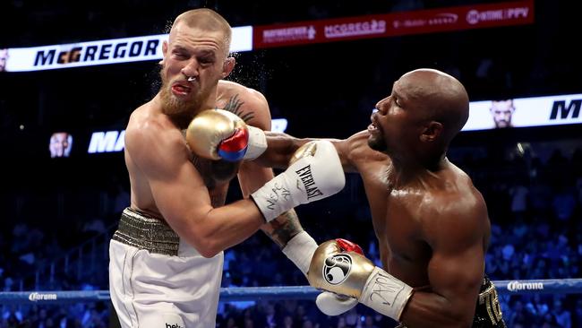 Floyd Mayweather lands a punch on Conor McGregor. Picture: Getty Images