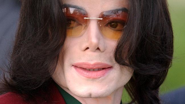 FILE - In this March 17, 2005 file photo, pop star Michael Jackson arrives at the Santa Barbara County Courthouse in Santa Maria, Calif. (AP Photo/Michael A. Mariant, file)