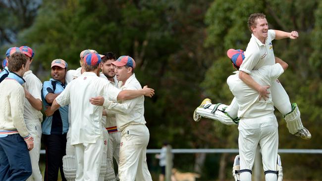 Toorak-Prahan players swamp batsmen Maurice Clayton and man of the match Hugo Trotter after winning the Menzies Shield in 2014. Picture by Steve Tanner.