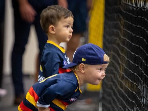 Hugo Walker and Sonny Sloane watch their dads in the changerooms after the Adelaide Crows win yesterday .  Picture: Adelaide Football Club