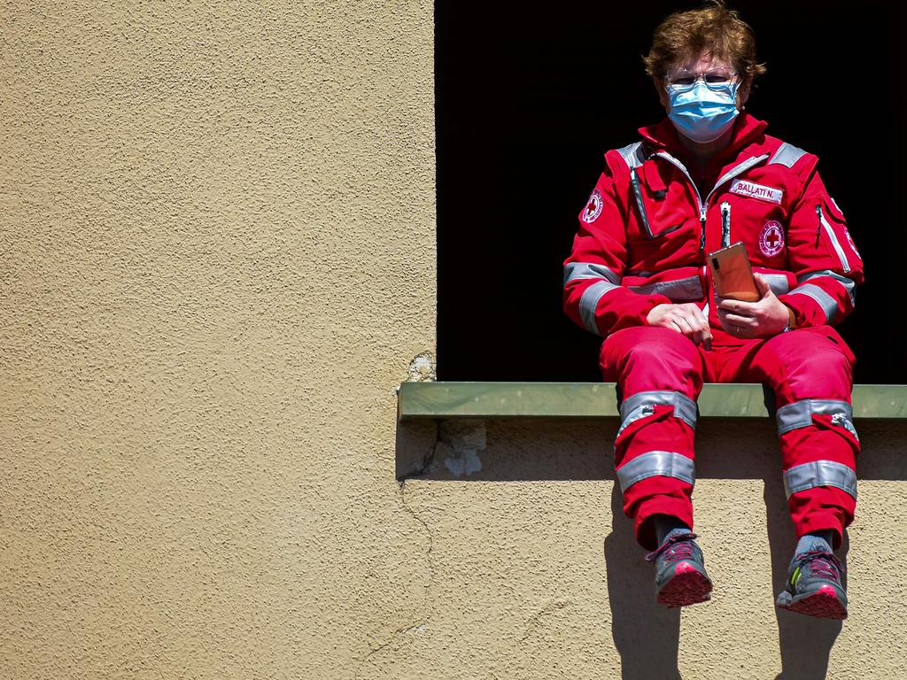 The C strain is most prevalent in Italy, where an Italian Red Cross worker watches a flash mob. Picture: Piero CRUCIATTI / AFP.