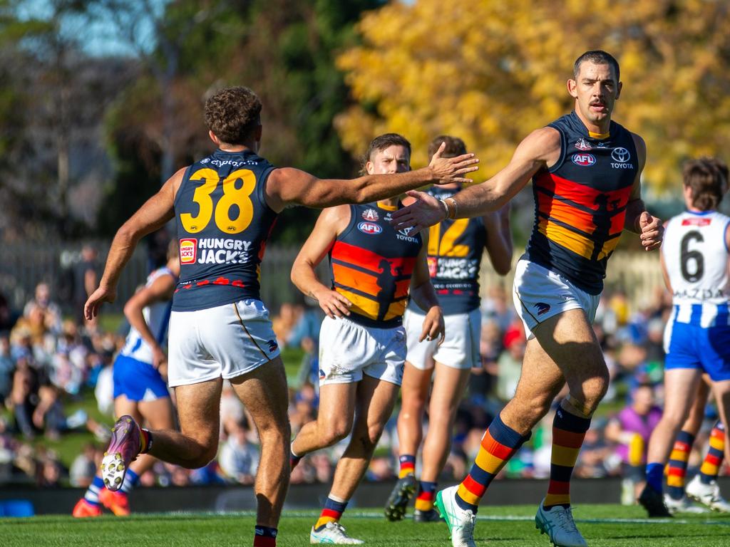 Taylor Walker and Lachie Sholl celebrate a goal. Picture: Linda Higginson/AFL Photos via Getty Images