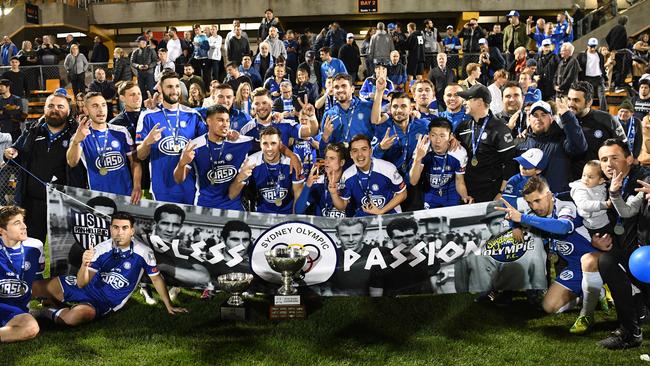 Olympic players and team officials with their trophy. Picture: Brendan Esposito