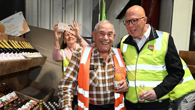Mr Dutton speaks with locals during a visit to the South Australian Produce Market in the electorate of Makin on Friday. Picture: Getty