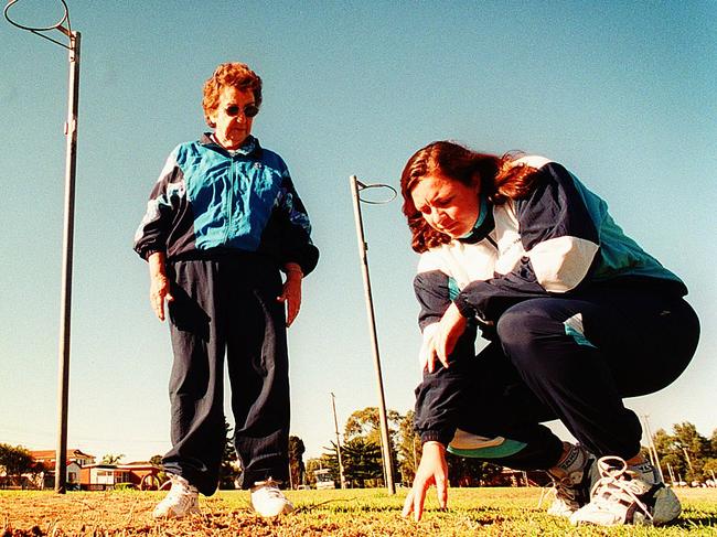 Gwen Winsor, left, and Cathryn Chiddy examining the grass courts at Curl Curl. Picture: Ros Cannon