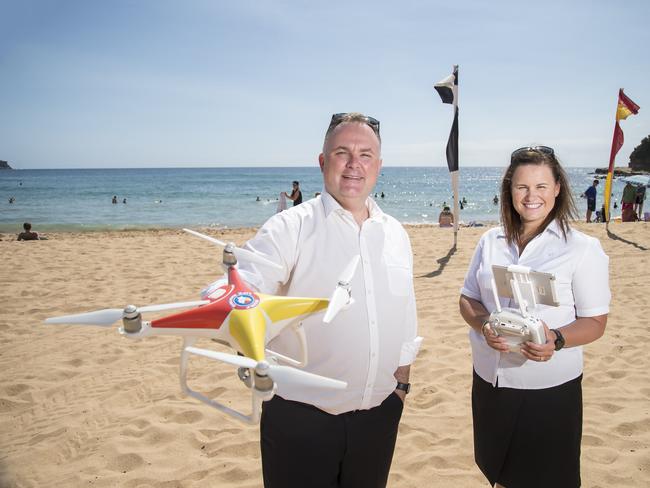 EXPRESS ADVOCATE/AAP. Member for Terrigal Adam Crouch & Surf Life Saving Central Coast marketing officer Narelle Duggan pose for a photograph with a drone at Avoca Beach on Tuesday, 17 December, 2019. A trial of a shark drone at Avoca Beach was set to be cancelled by the DPI however was saved by Member for Terrigal Adam Crouch. (AAP IMAGE / Troy Snook)