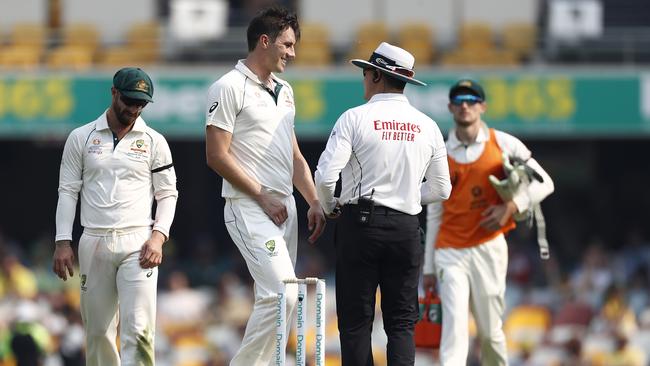 Pat Cummins laughs with umpire Richard Kettleborough as his no-ball delivery claims the wicket of Mohammad Rizwan. Picture: Getty