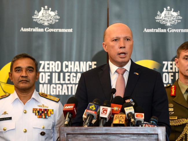 Australia's Home Minister Peter Dutton (C) speaks to the media as Sri Lanka's navy commander Piyal De Silva (L), and the head of Australia's Operation Sovereign Borders Major General Craig Furini (R) look on in Colombo on June 4, 2019. - Australia On June 4 launched a fresh initiative in Sri Lanka to discourage would-be illegal immigrants following an uptick in people- smuggling attempts last month. Home Minister Peter Dutton told reporters in Colombo that there was an increase in the number of attempts to illegally enter Australia by boat in the past month, but no one was successful. (Photo by STR / AFP)