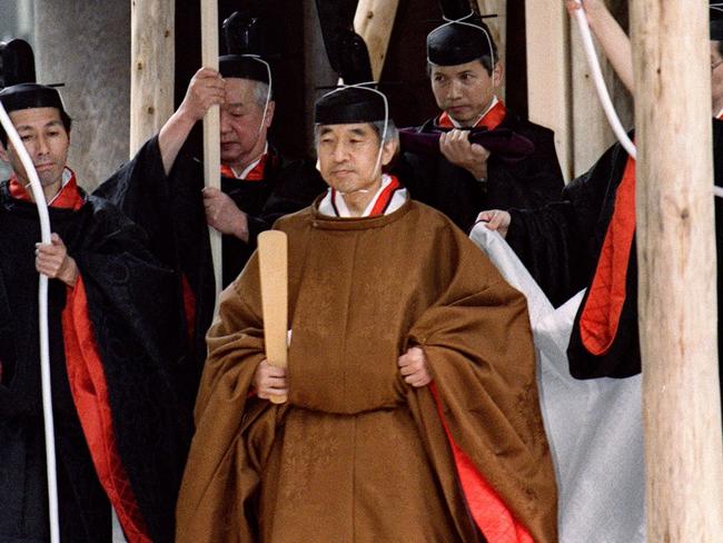 This file picture taken on November 27, 1990 shows Japanese Emperor Akihito (C) walking toward a carriage after he reported his enthronement to the deity of the outer shrine at Ise. Picture: AFP.